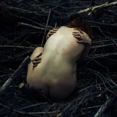  Female nude: naked woman embraced by nature.