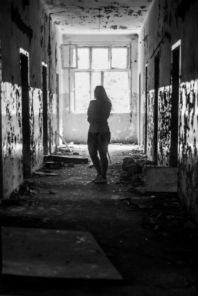 Woman walks around abandoned hospital in straitjacket
