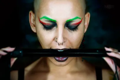 tattooed woman with piercings and colored hair