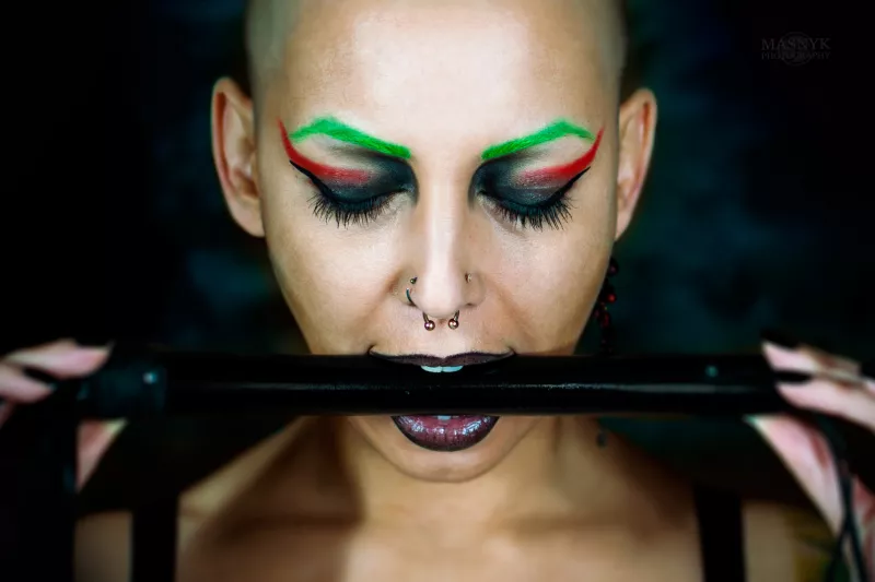 tattooed woman with piercings and colored hair