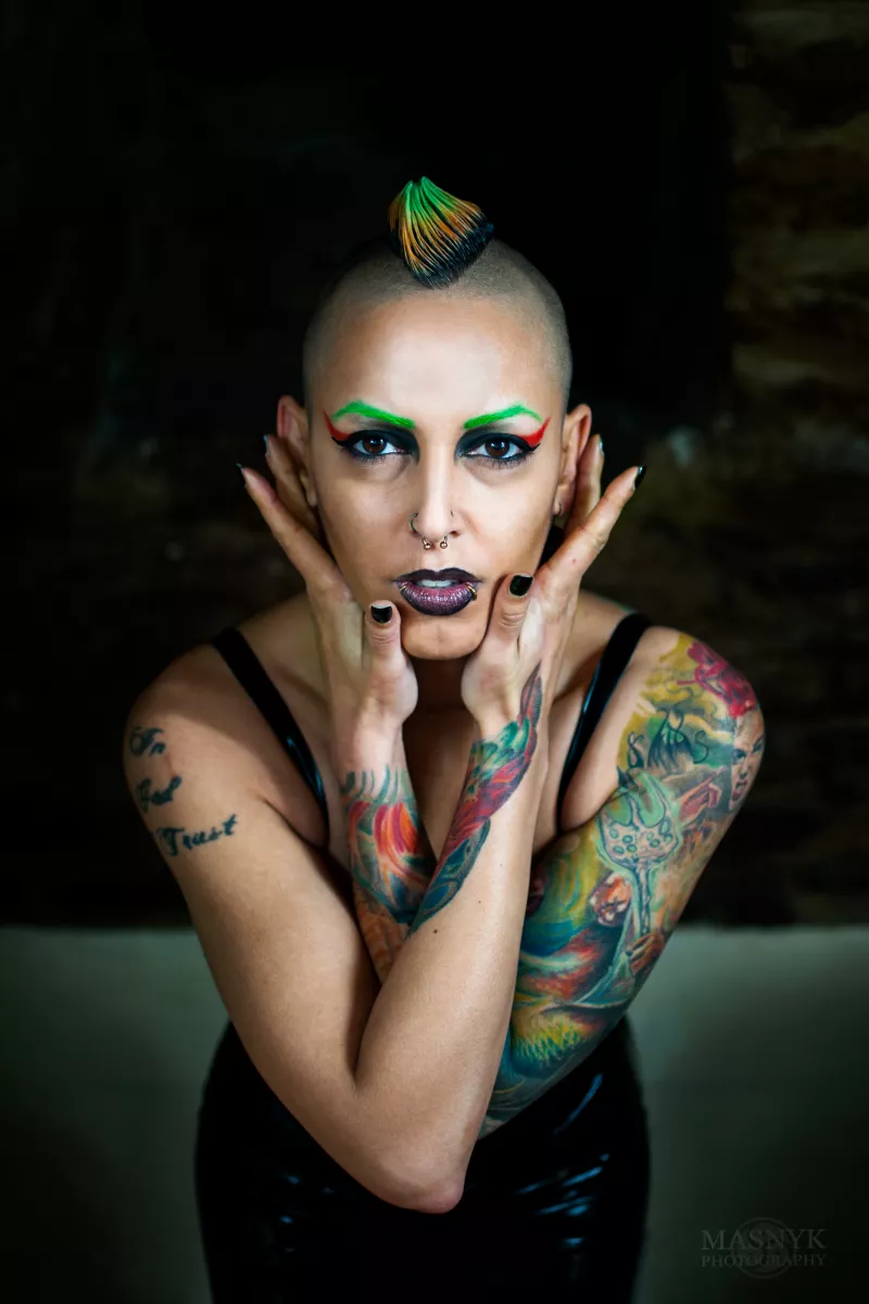 tattooed woman with piercings and colored hair