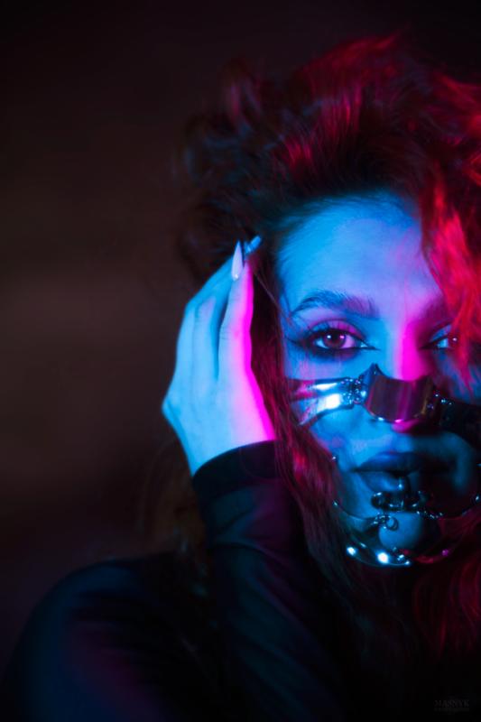 Artistic portrait with neon blue and pink lighting