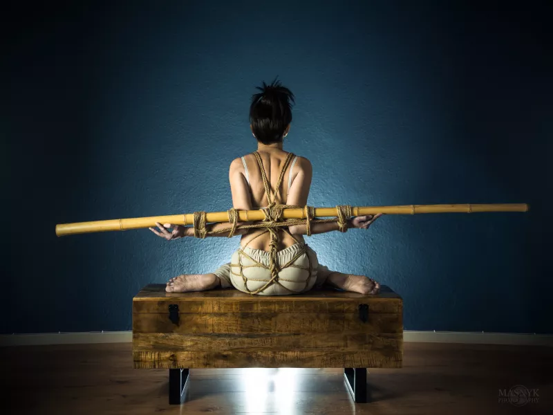 tied up girl with the use of ropes and bamboo