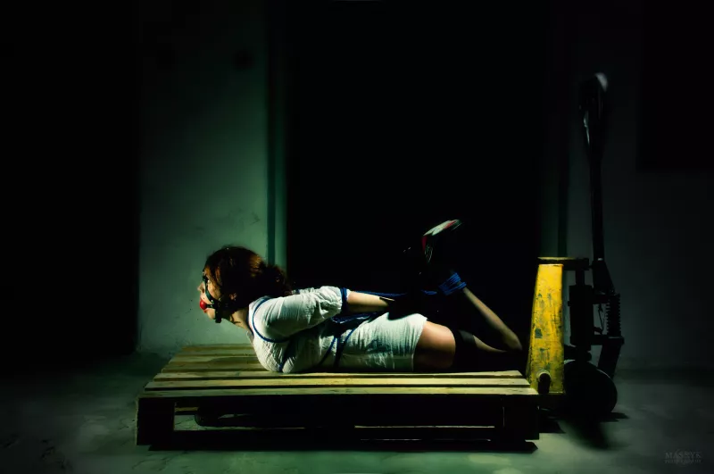 Bound and gagged woman on pallet jack