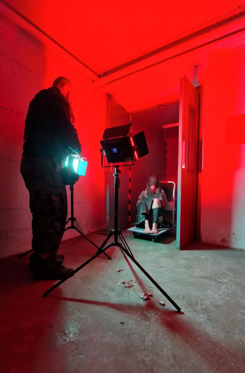 Artistic photo shoot with red lighting in an abandoned factory