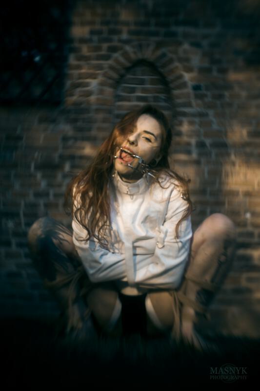 gagged woman in a straitjacket