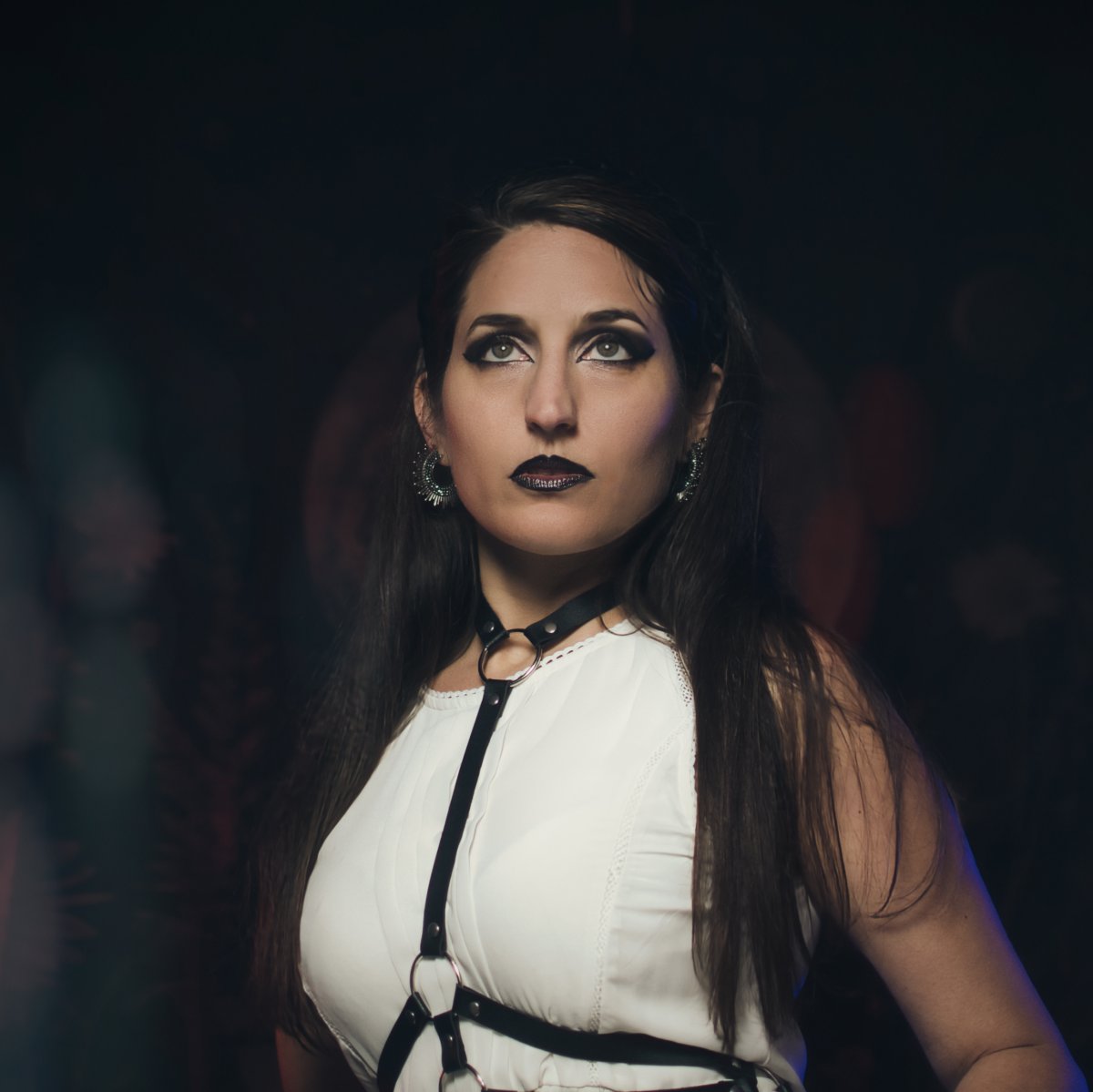 Woman in a white dress with dark makeup