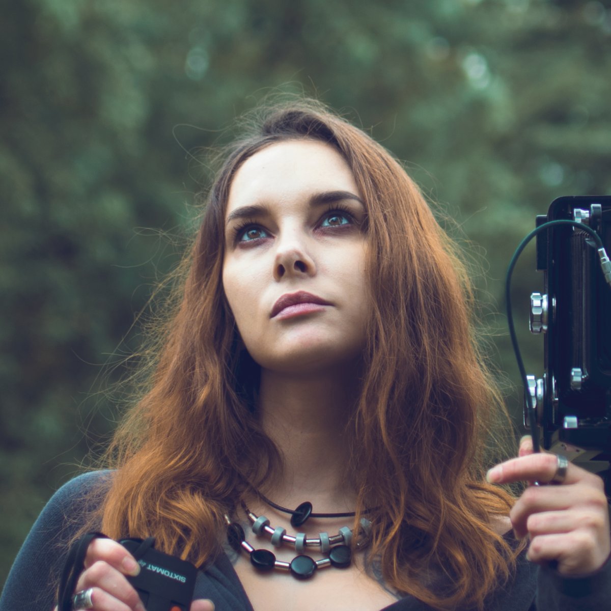  Photo of a woman taking a picture with a large-format camera. 