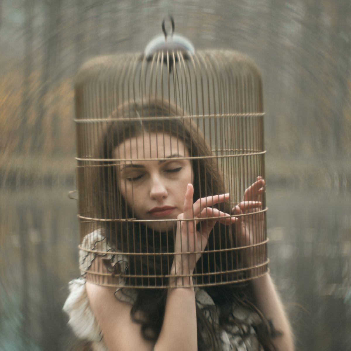 Dreamy woman with her head in a cage